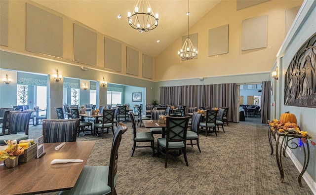 carpeted dining room featuring a chandelier and high vaulted ceiling