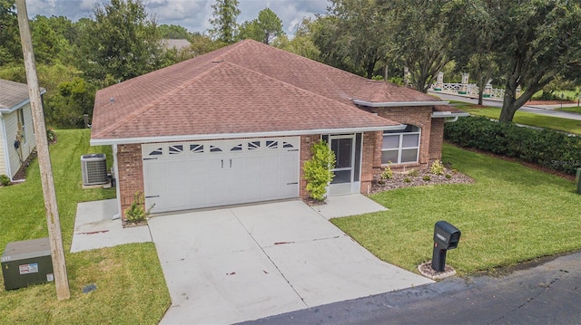 ranch-style home with central AC unit, a front yard, and a garage