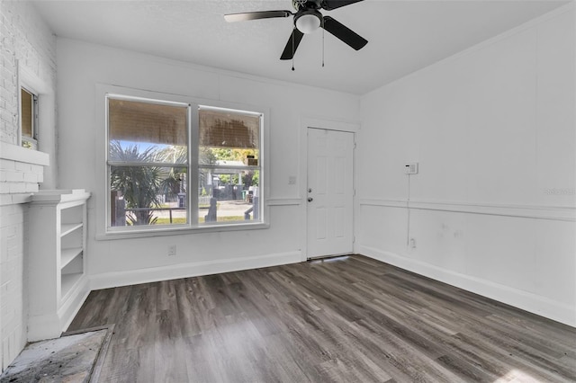 interior space featuring a fireplace, dark hardwood / wood-style flooring, and ceiling fan