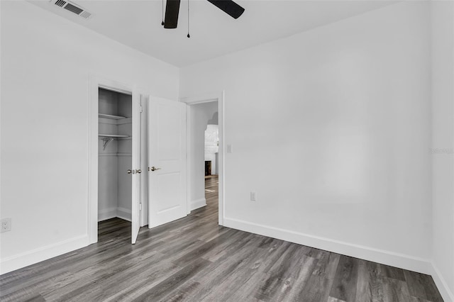 unfurnished bedroom with a closet, ceiling fan, and hardwood / wood-style floors