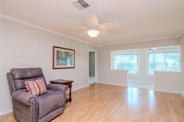 sitting room featuring ceiling fan, ornamental molding, and light hardwood / wood-style floors