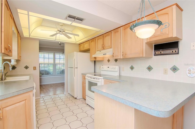 kitchen featuring light hardwood / wood-style flooring, white appliances, sink, and backsplash