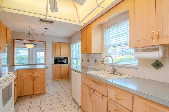 kitchen with decorative backsplash, light brown cabinets, light tile patterned flooring, white appliances, and sink