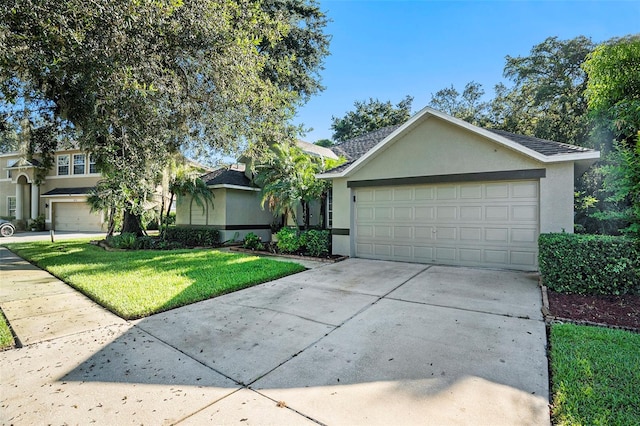 ranch-style home with a garage and a front lawn