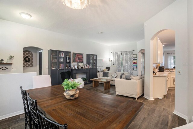 dining room with dark hardwood / wood-style flooring and sink