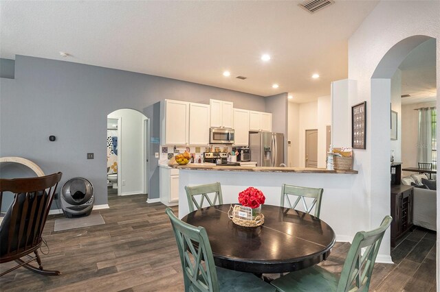 dining area featuring dark hardwood / wood-style flooring