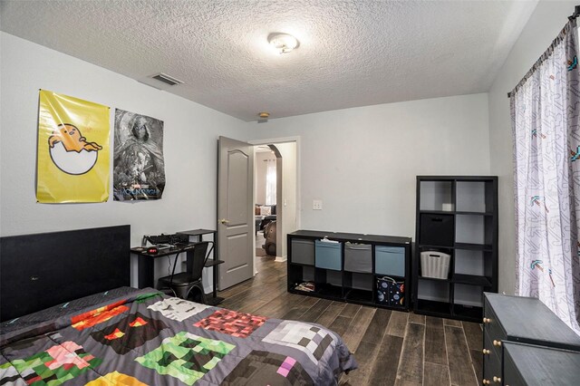 office area with a textured ceiling and dark hardwood / wood-style floors