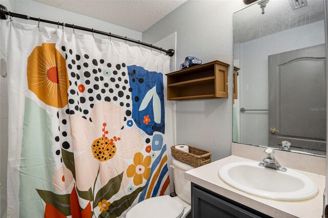 bathroom featuring walk in shower, toilet, a textured ceiling, and vanity