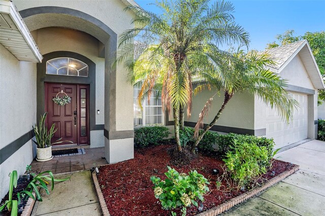 view of exterior entry featuring a garage