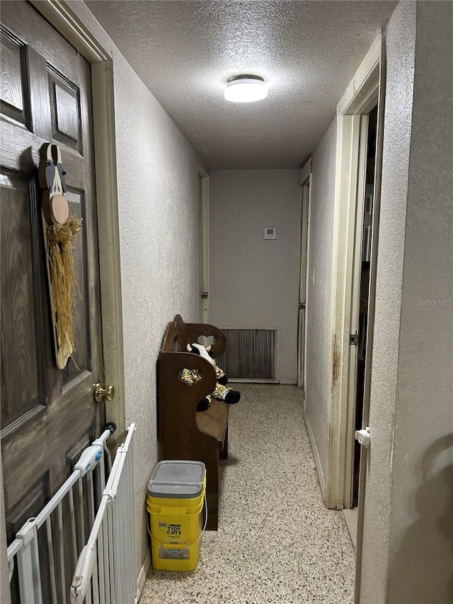 hallway featuring a textured ceiling