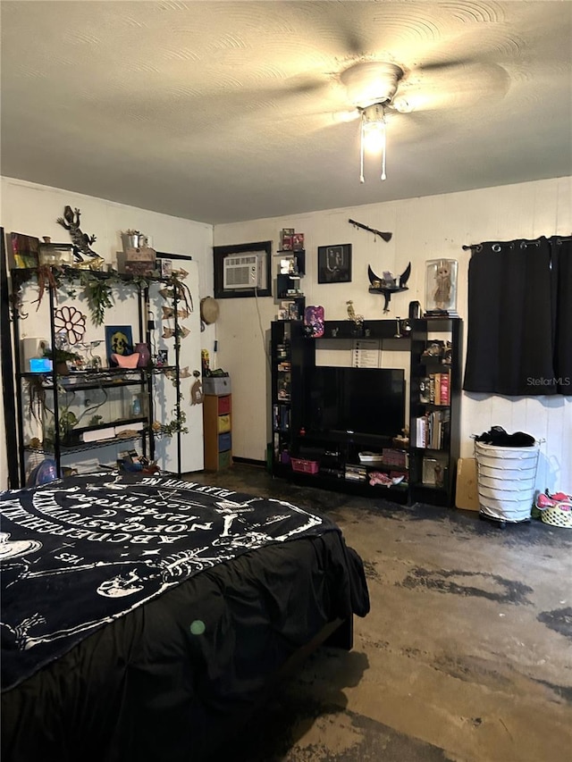 bedroom with concrete flooring, an AC wall unit, and ceiling fan