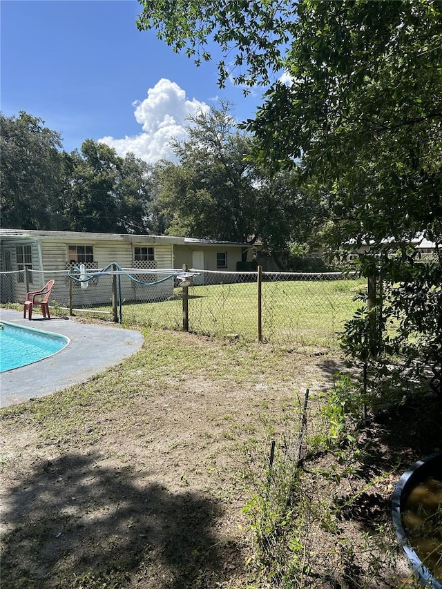 view of yard with a fenced in pool