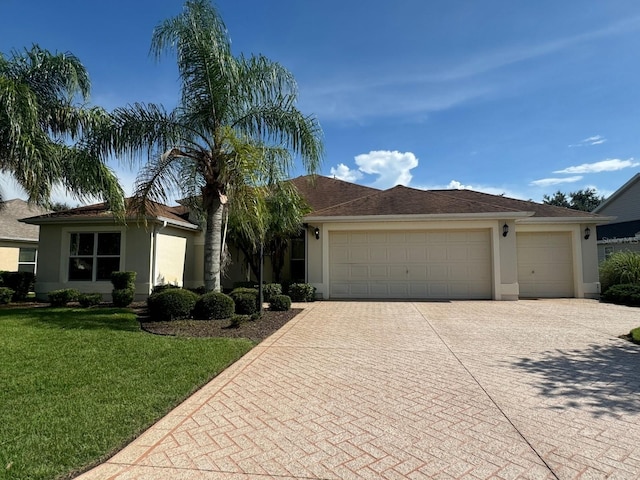 ranch-style house featuring a garage and a front yard