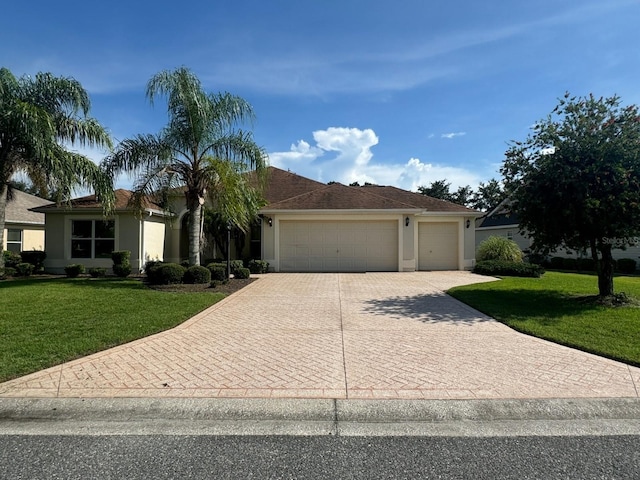 view of front of home with a garage and a front lawn