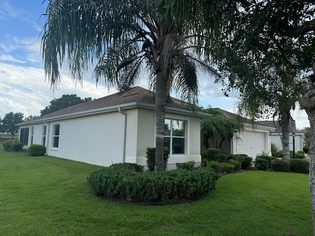 view of property exterior featuring a yard and a garage