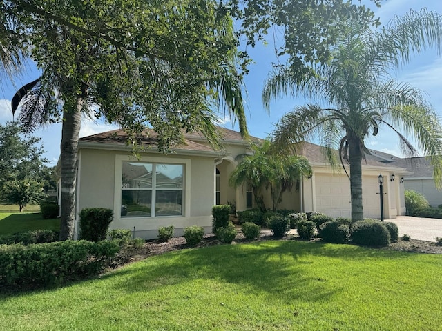 view of front of house with a garage and a front lawn