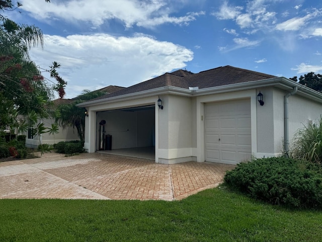 view of home's exterior featuring a lawn and a garage