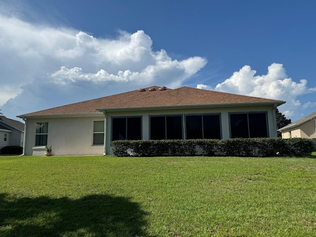 rear view of house with a lawn