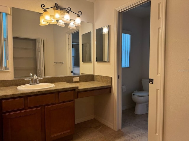 bathroom featuring tile patterned flooring, vanity, and toilet