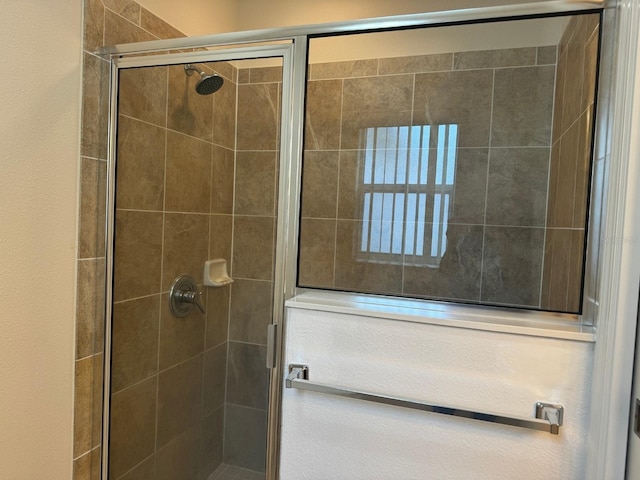 bathroom with a shower with shower door