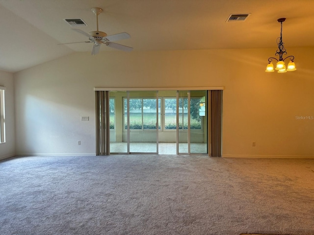 carpeted spare room with ceiling fan and vaulted ceiling