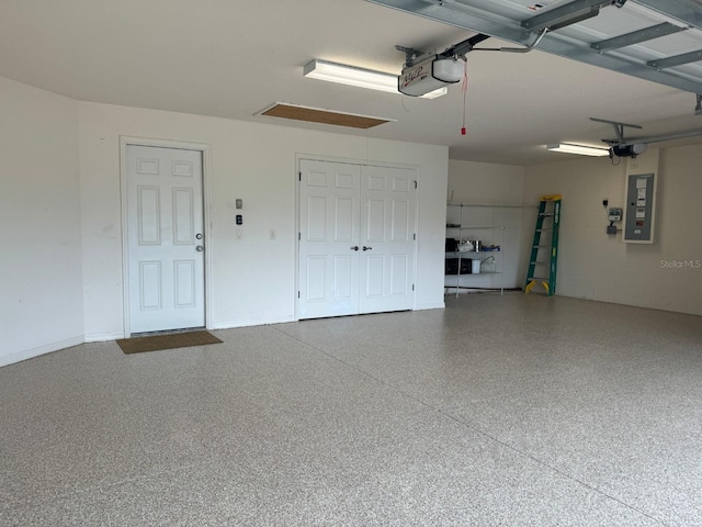 garage featuring electric panel and a garage door opener