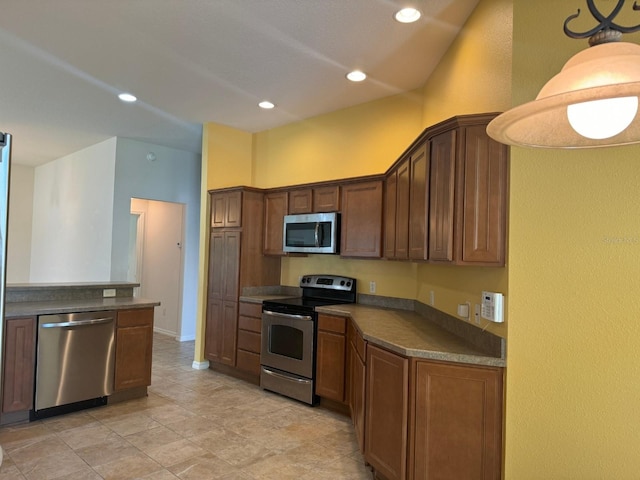 kitchen with hanging light fixtures and appliances with stainless steel finishes