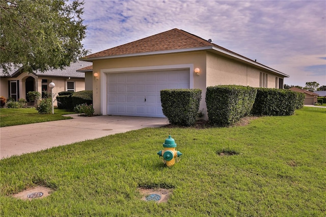 view of front facade with a garage and a yard