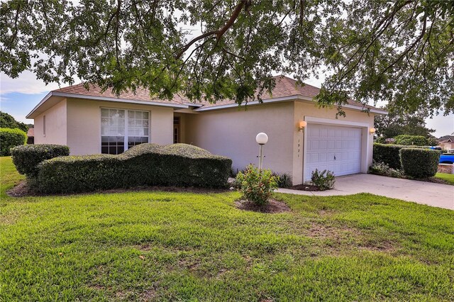 single story home with a garage and a front yard