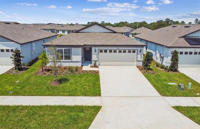 ranch-style house featuring a garage and a front lawn