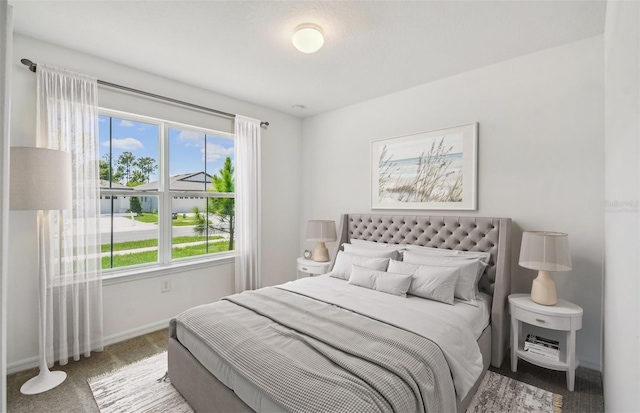 carpeted bedroom featuring multiple windows