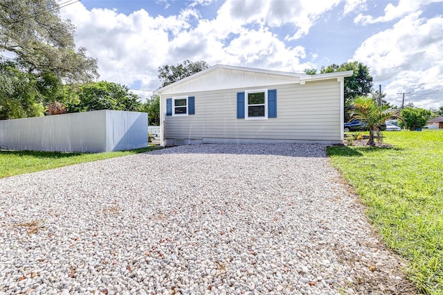 view of side of home featuring a yard