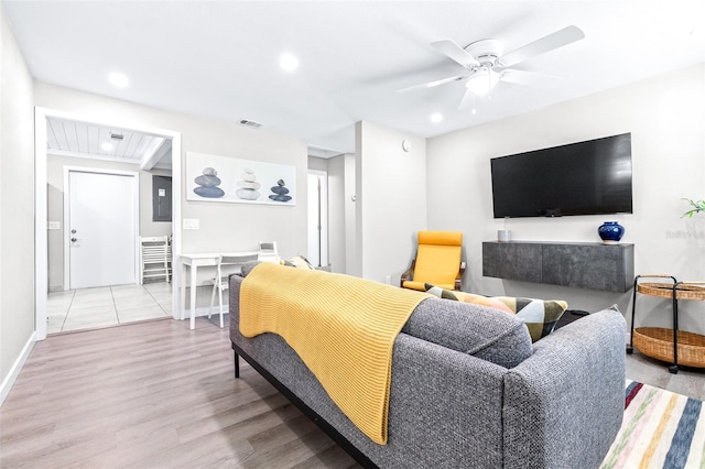 living room with ceiling fan and light wood-type flooring