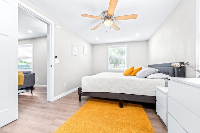 bedroom with ceiling fan and light wood-type flooring