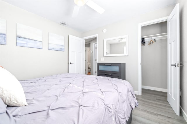 bedroom with a closet, ceiling fan, and light wood-type flooring