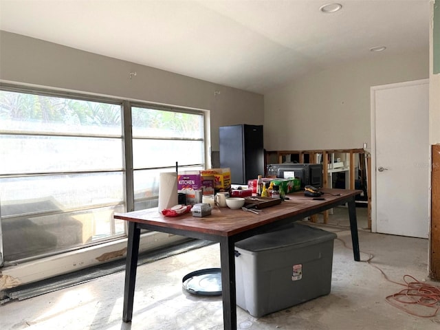 dining area with a wealth of natural light and vaulted ceiling