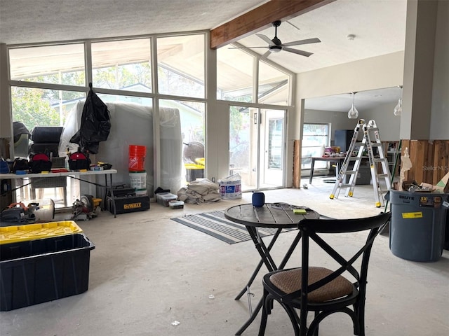 interior space with vaulted ceiling with beams, ceiling fan, concrete floors, and electric water heater