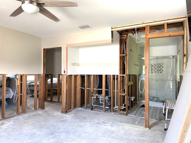 misc room with ceiling fan and concrete floors