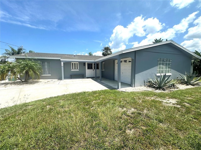 view of front of property with a garage and a front lawn