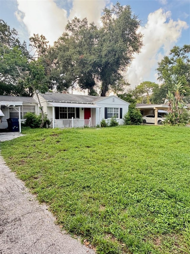 ranch-style house with a front lawn and a carport