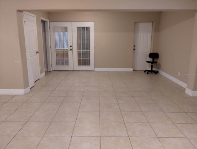 unfurnished room featuring light tile patterned flooring and french doors