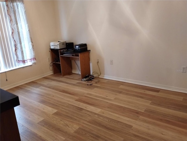 unfurnished office featuring hardwood / wood-style floors