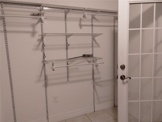 spacious closet featuring light tile patterned floors