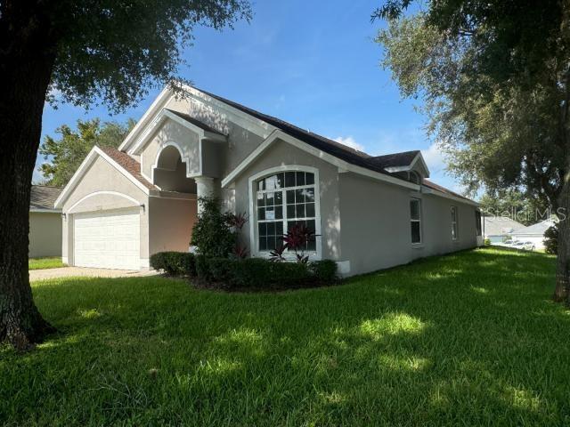 exterior space featuring a garage and a front lawn