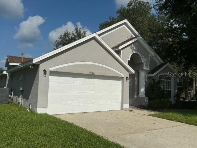 view of property exterior featuring central AC unit and a garage