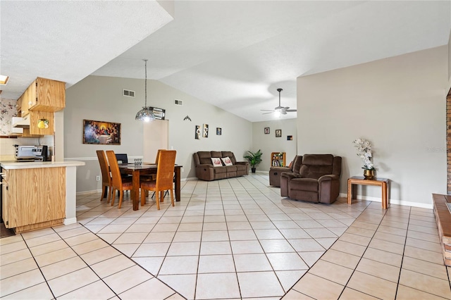 tiled living room with ceiling fan and high vaulted ceiling