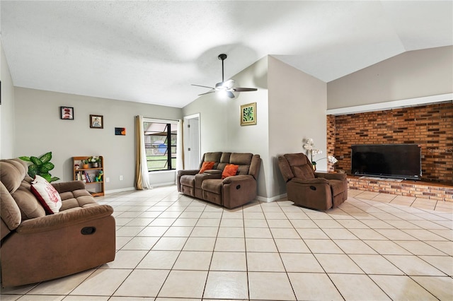 living room featuring ceiling fan, a fireplace, light tile patterned flooring, and lofted ceiling