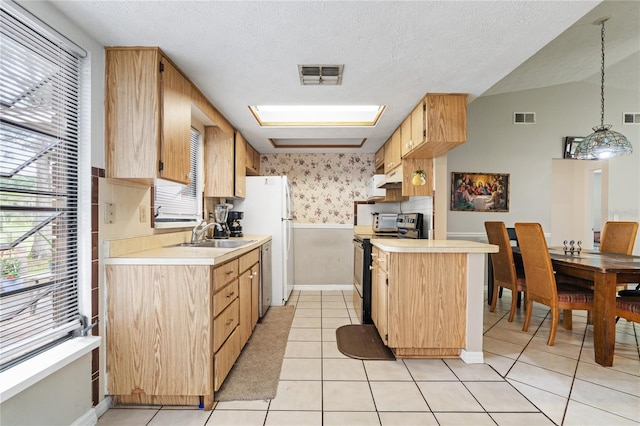 kitchen with stainless steel appliances, a textured ceiling, light tile patterned floors, sink, and decorative light fixtures