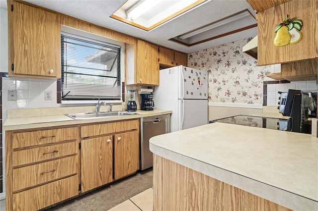 kitchen with tasteful backsplash, dishwasher, light tile patterned floors, sink, and white fridge