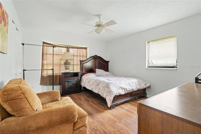 bedroom with ceiling fan and hardwood / wood-style flooring